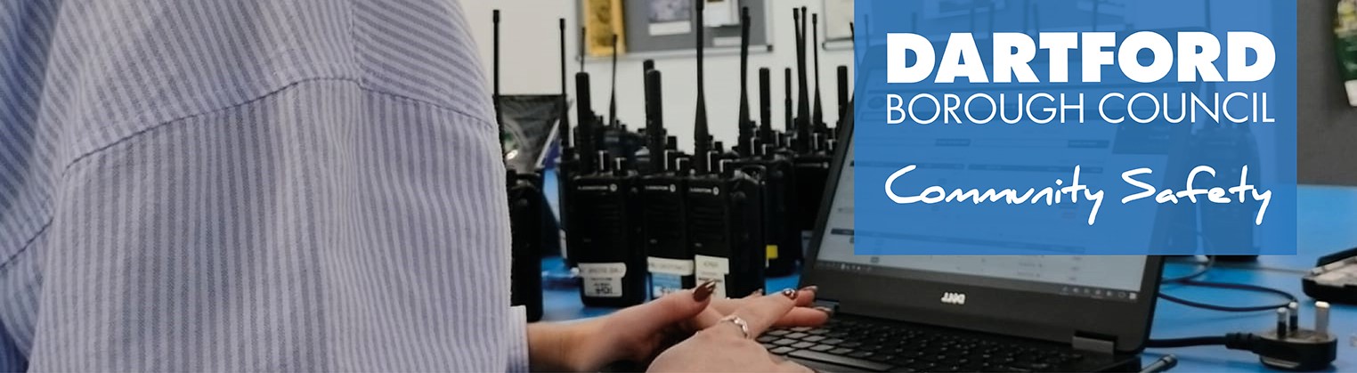 Hands of someone typing on a laptop, text reads Dartford Borough Council community safety