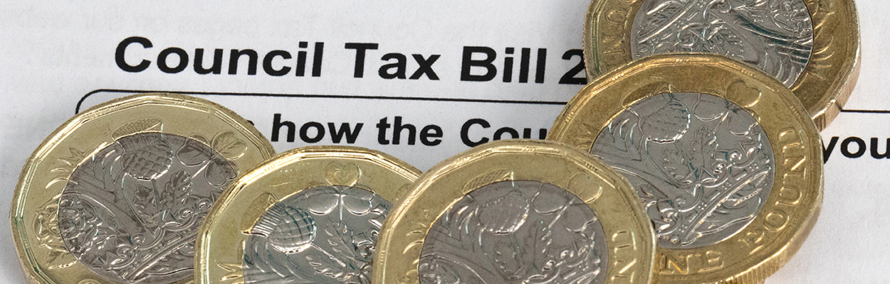 Pound coins on a council tax bill